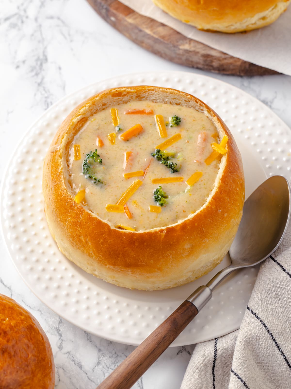 Bread bowl filled with creamy broccoli cheddar soup perfect for a comforting dinner.