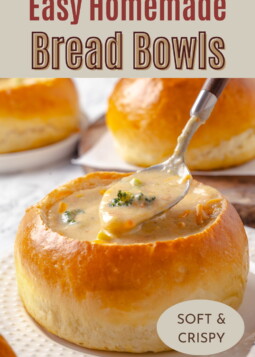 Golden baked bread bowls arranged on parchment, perfect for serving warm broccoli cheddar soup.