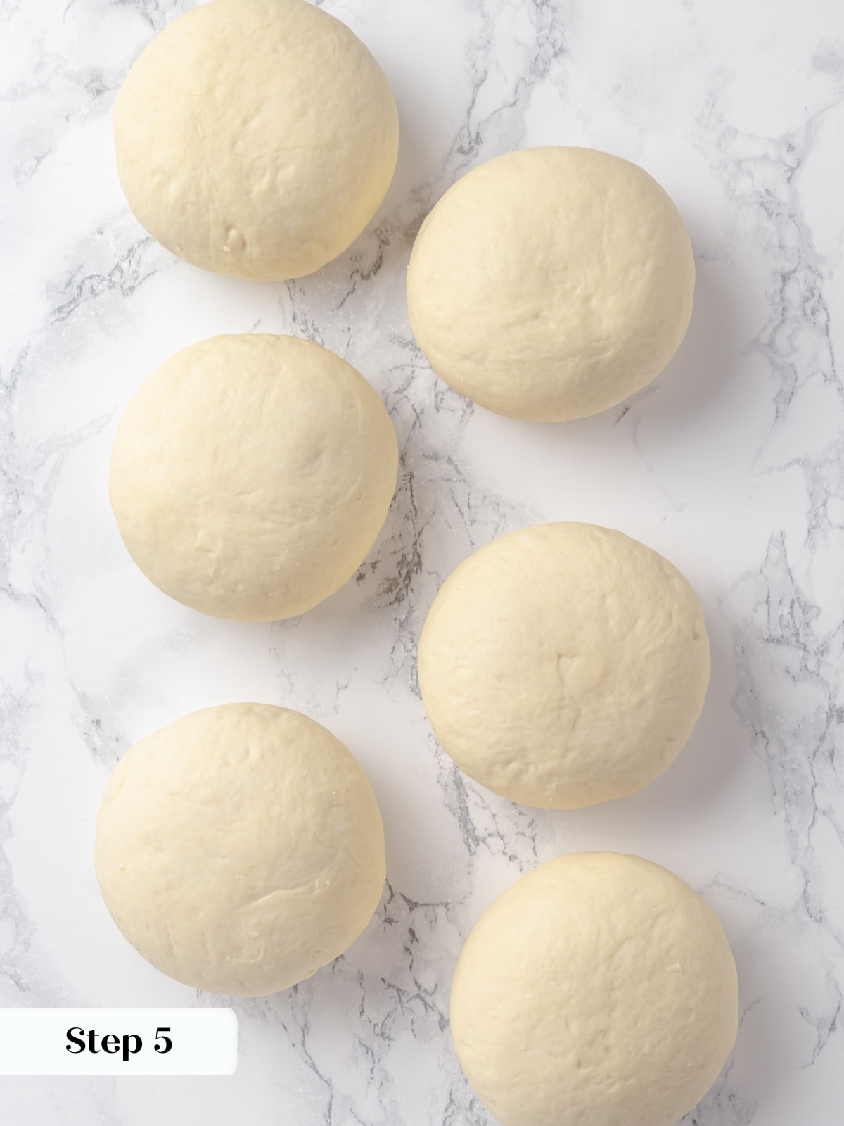 Six dough balls portioned evenly and arranged for the shaping process.