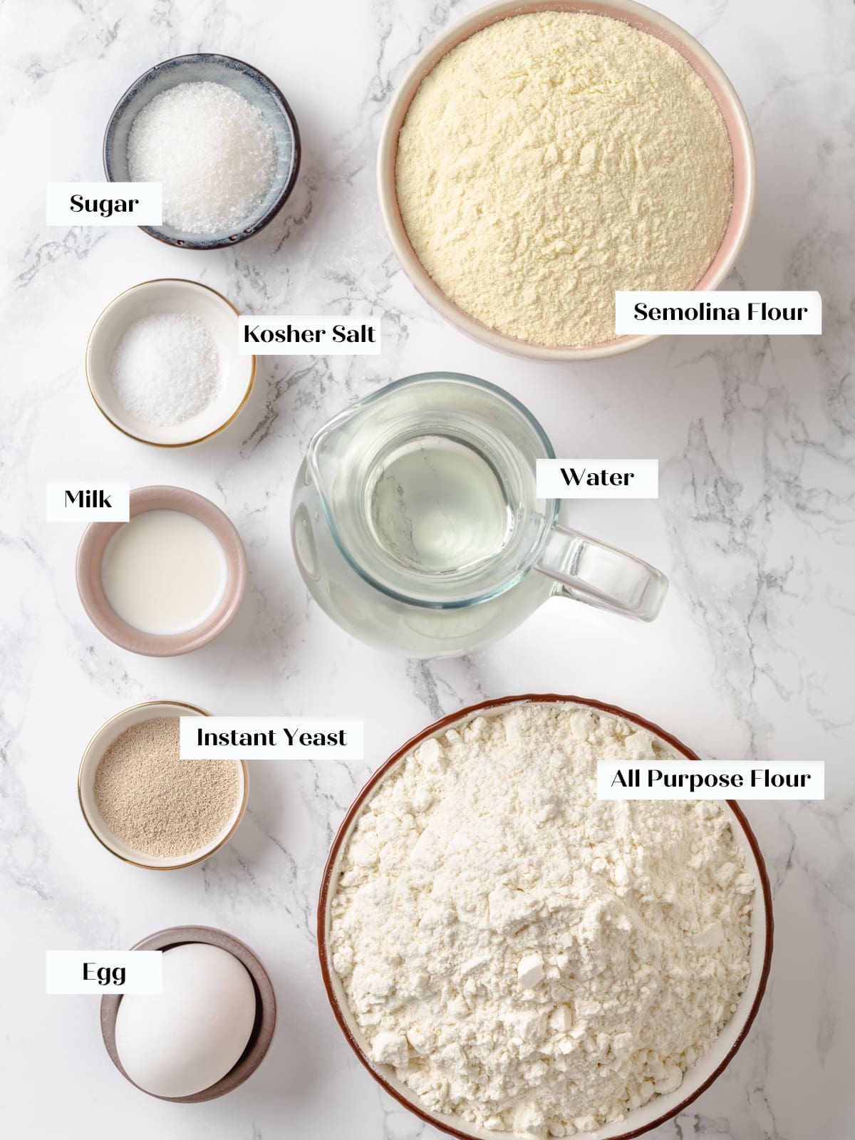Ingredients for homemade bread bowls arranged on a counter before mixing the dough.