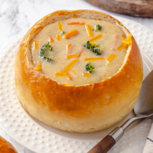 Creamy soup nestled inside a golden bread bowl ready to serve for dinner.