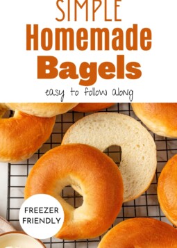 A batch of warm bagels cooling on a rack with a smooth surface and classic texture.