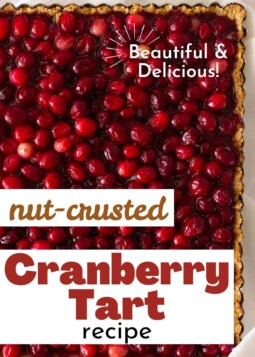 A sheet pan of brightly colored tart with fresh cranberries in a walnut crust.