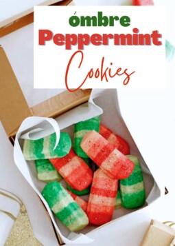Colorful red and green peppermint cookies topped with sparkling sugar in a gift box.
