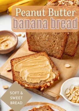 A warm slice of peanut butter banana bread spread lightly with peanut butter on a cutting board.
