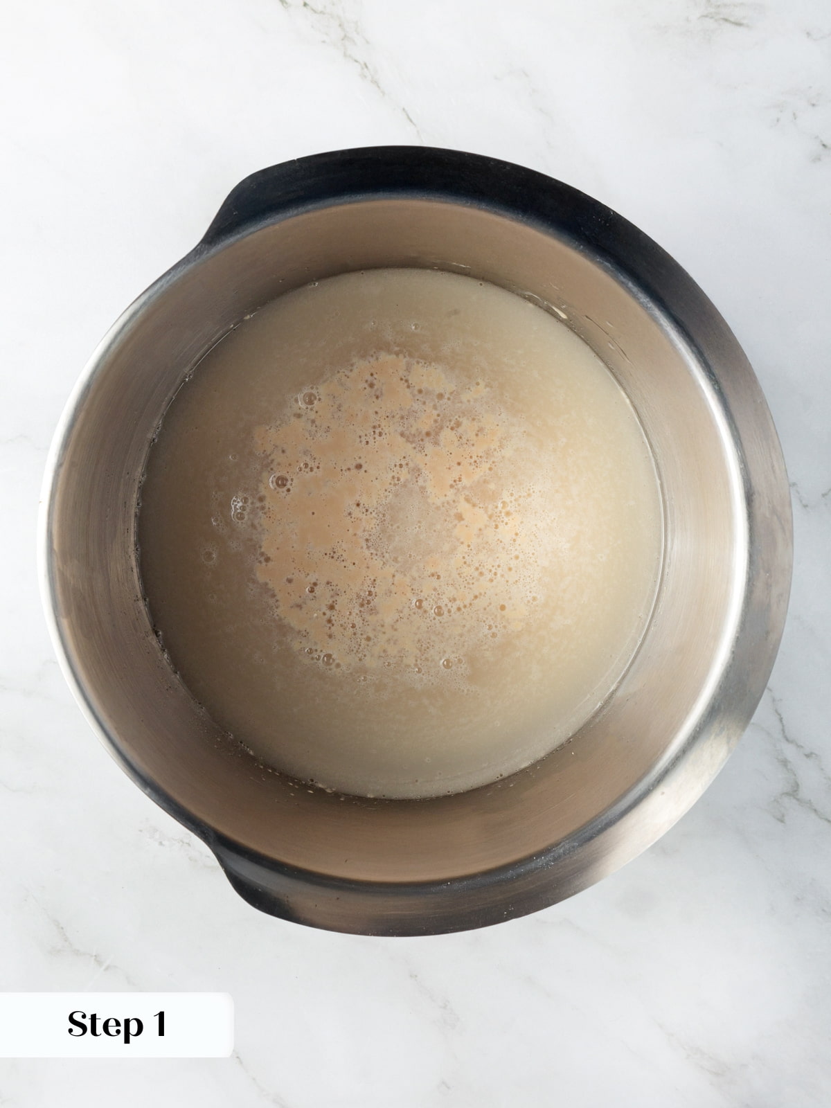 Active yeast blooming in warm water before mixing into the dough for soft rye loaves.