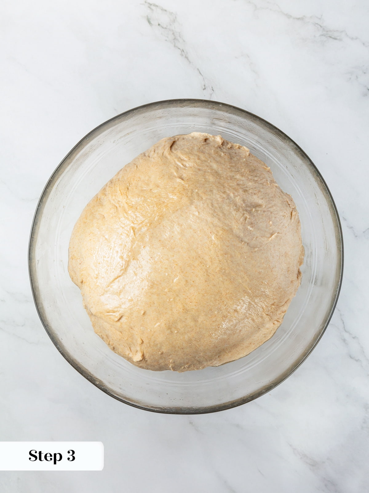 Soft rye dough formed into a round shape, ready for the next step in preparation.