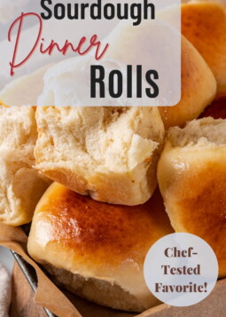 Twelve sourdough dinner rolls baked until lightly golden and placed together for sharing.