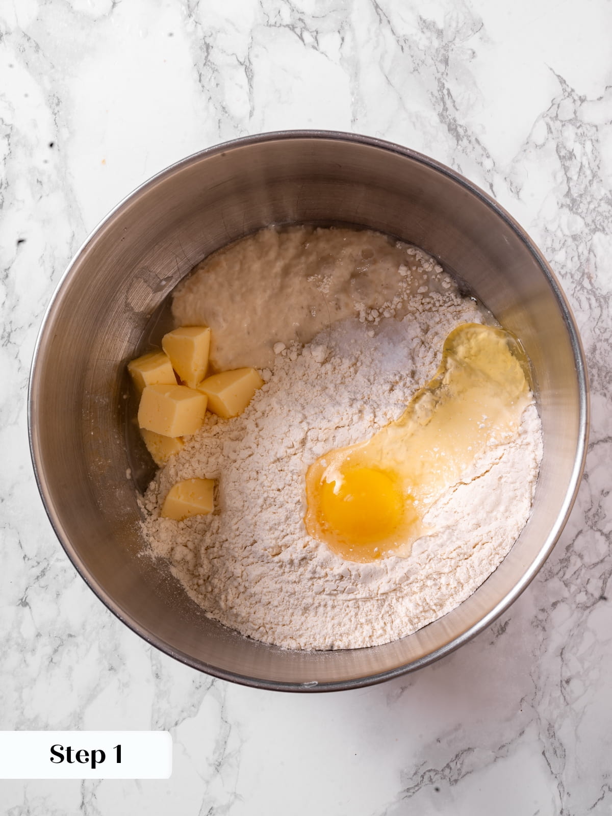 Ingredients for sourdough dinner rolls gathered in a bowl before mixing into dough.