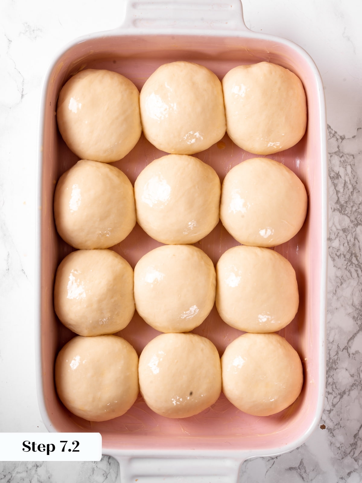 Sourdough dough balls after rising until very puffy and full inside the baking dish.