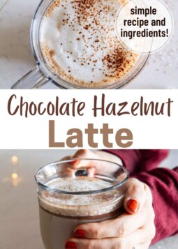 Warm chocolate hazelnut latte topped with cocoa powder held in a glass mug.