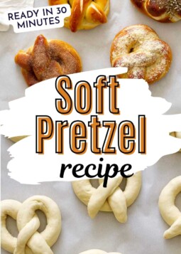 Variety of soft pretzels arranged on parchment with topped with salt, cinnamon sugar, garlic Parmesan, and za’atar sesame.