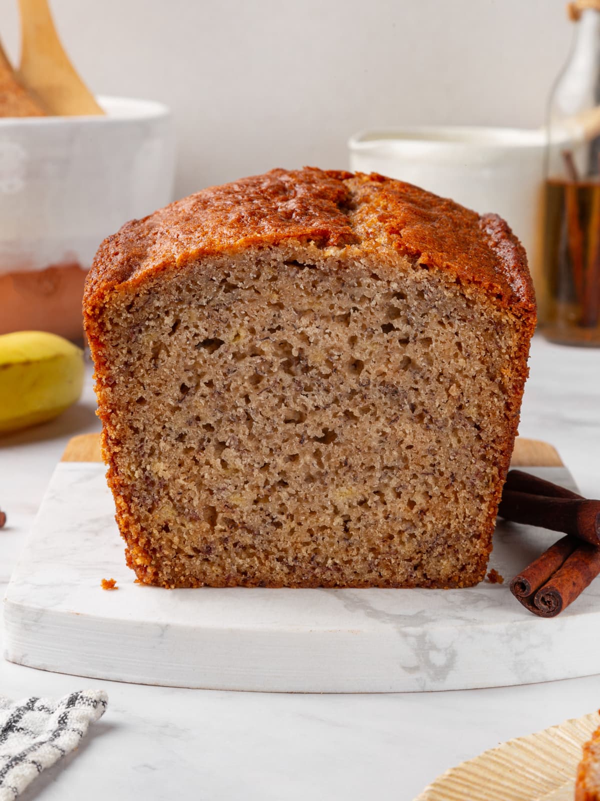 Whole sourdough banana bread loaf sliced to show soft moist crumb and golden crust.