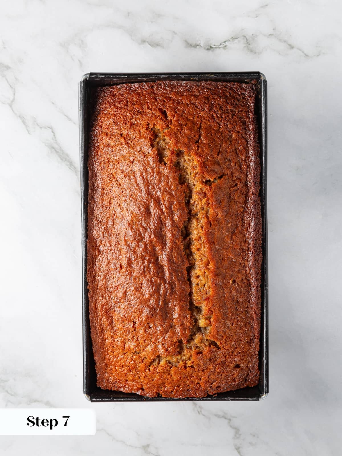 Baked sourdough banana bread loaf resting after oven baking stage.