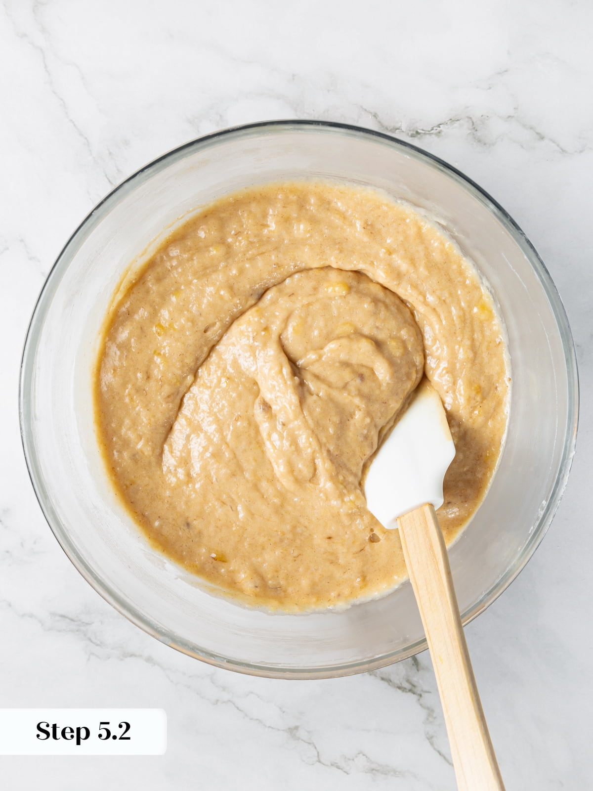 Banana bread batter mixed just until combined with slightly lumpy texture.