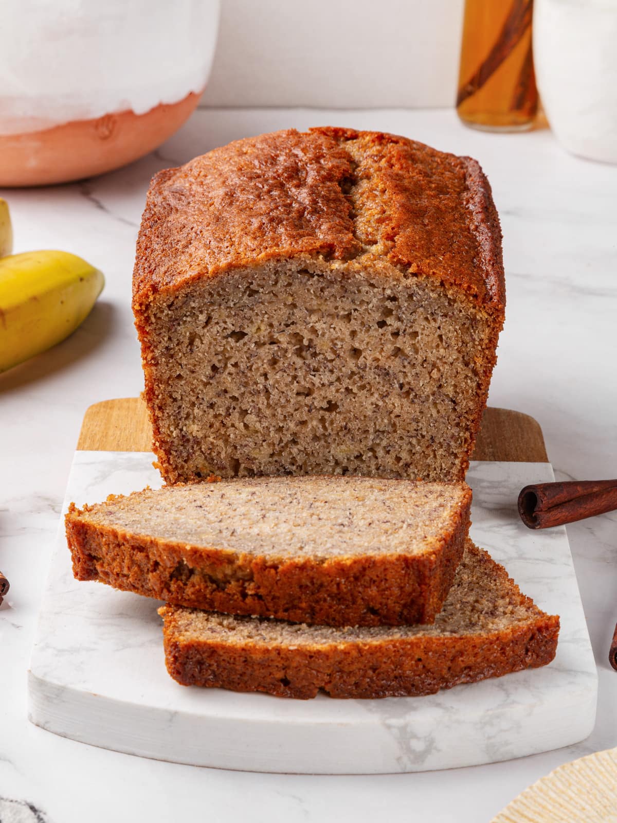 Thick slices of sourdough banana bread arranged on cutting board.