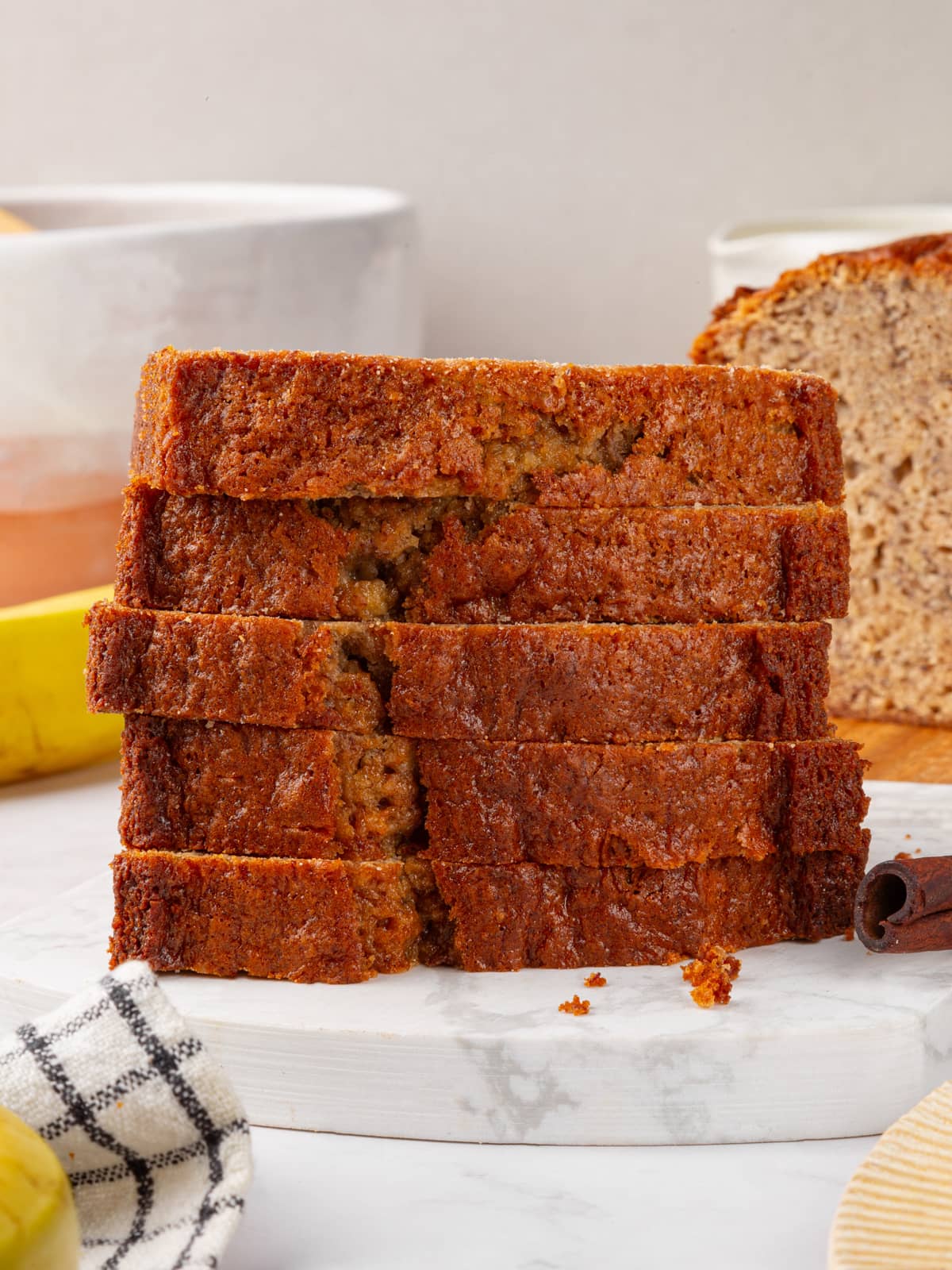 Neatly stacked banana bread slices ready for serving or storage.
