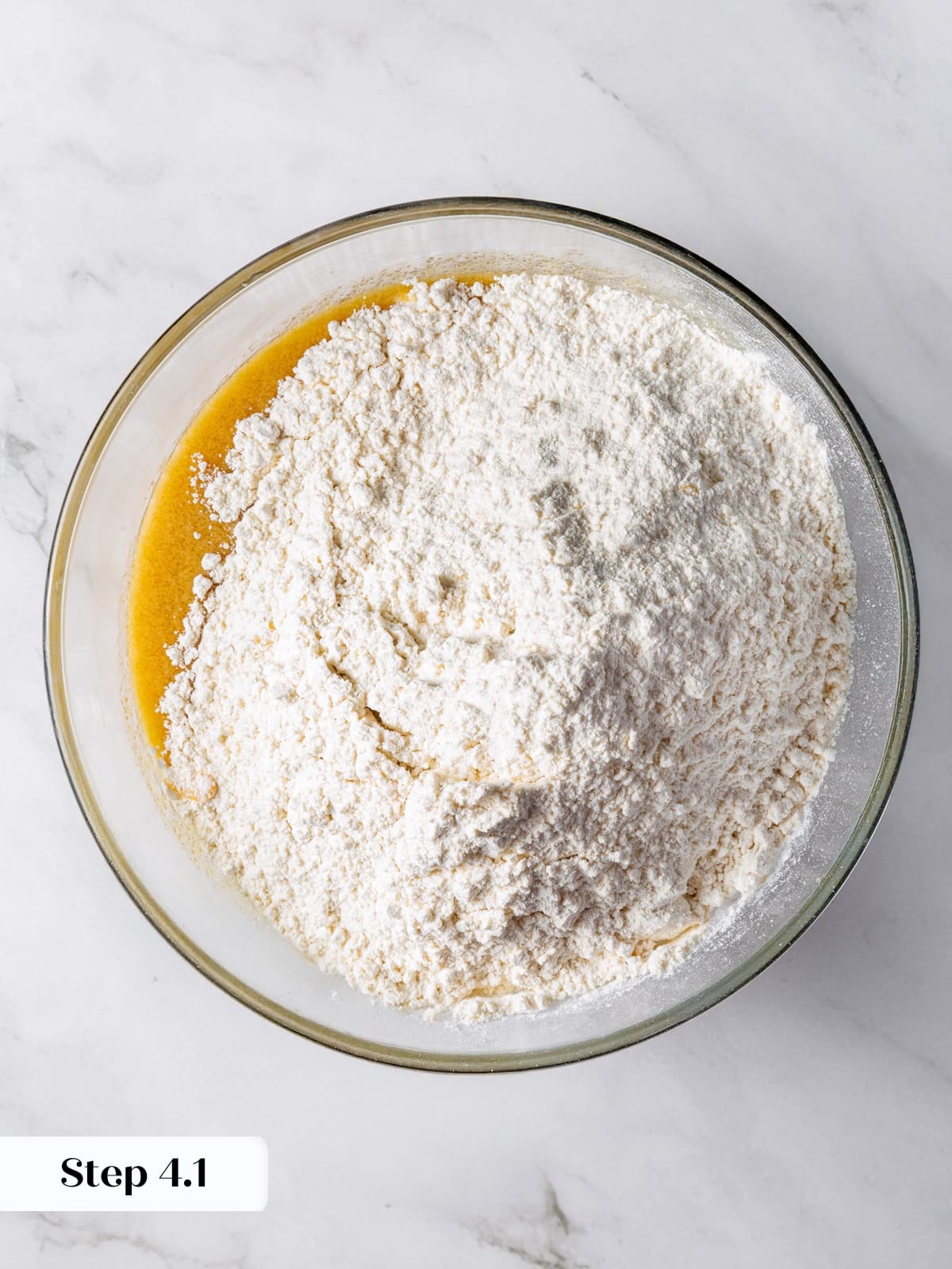 Flour mixture being incorporated into wet ingredients for sourdough cookie dough.