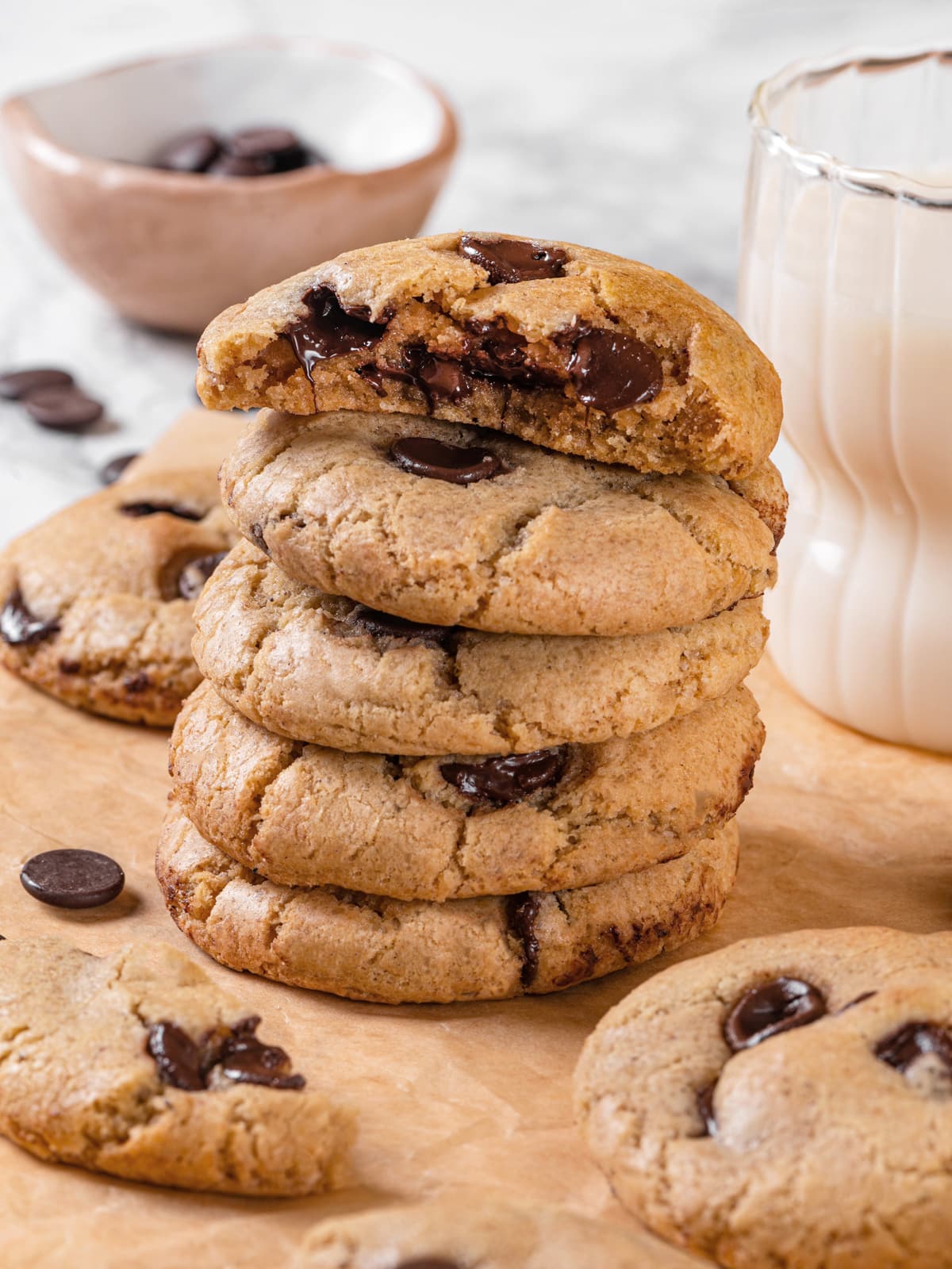 Stack of sourdough chocolate chip cookies with one cookie broken open.
