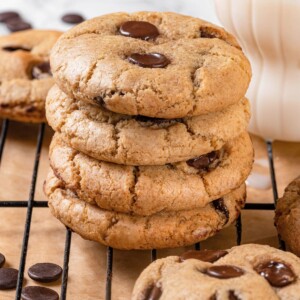 Stack of four sourdough chocolate chip cookies with thick chewy appearance.