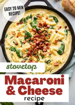 Creamy macaroni and cheese with spinach and crispy pancetta in a cast iron skillet.