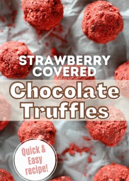 Rich dark chocolate truffles covered in powdered strawberry arranged on parchment.