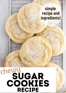 Soft chewy sugar cookies with sparkling sugar topping piled on a wire cooling rack.