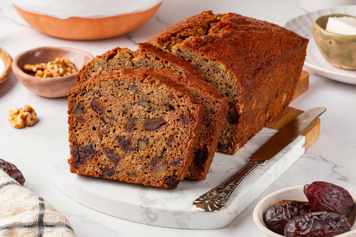 Date nut bread interior dotted with softened dates throughout the crumb.