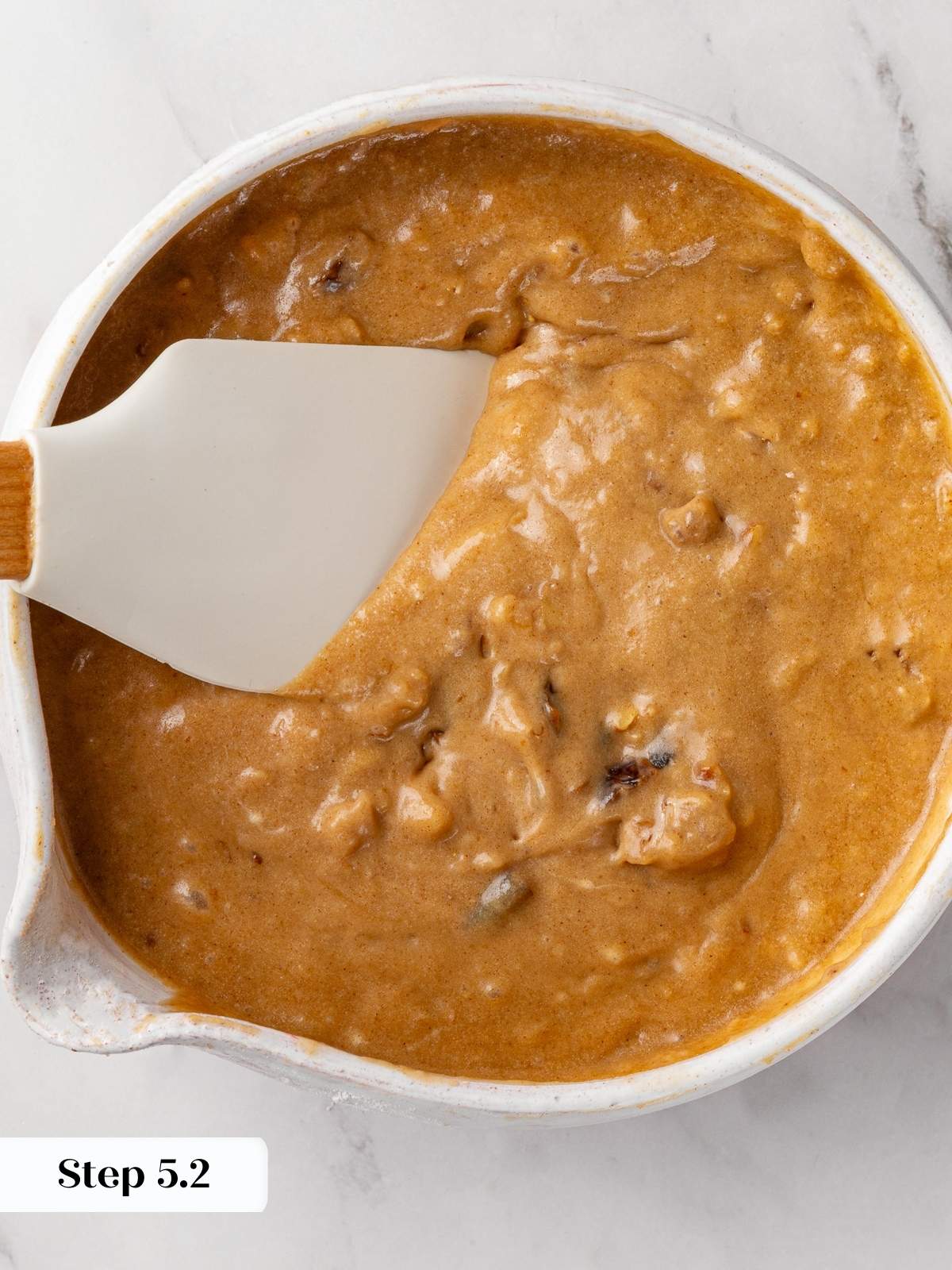 Chopped walnuts folded into date nut bread batter by hand.