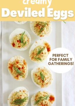 Arrangement of creamy deviled eggs topped with paprika and dill. Text overlay reads perfect for family gatherings.