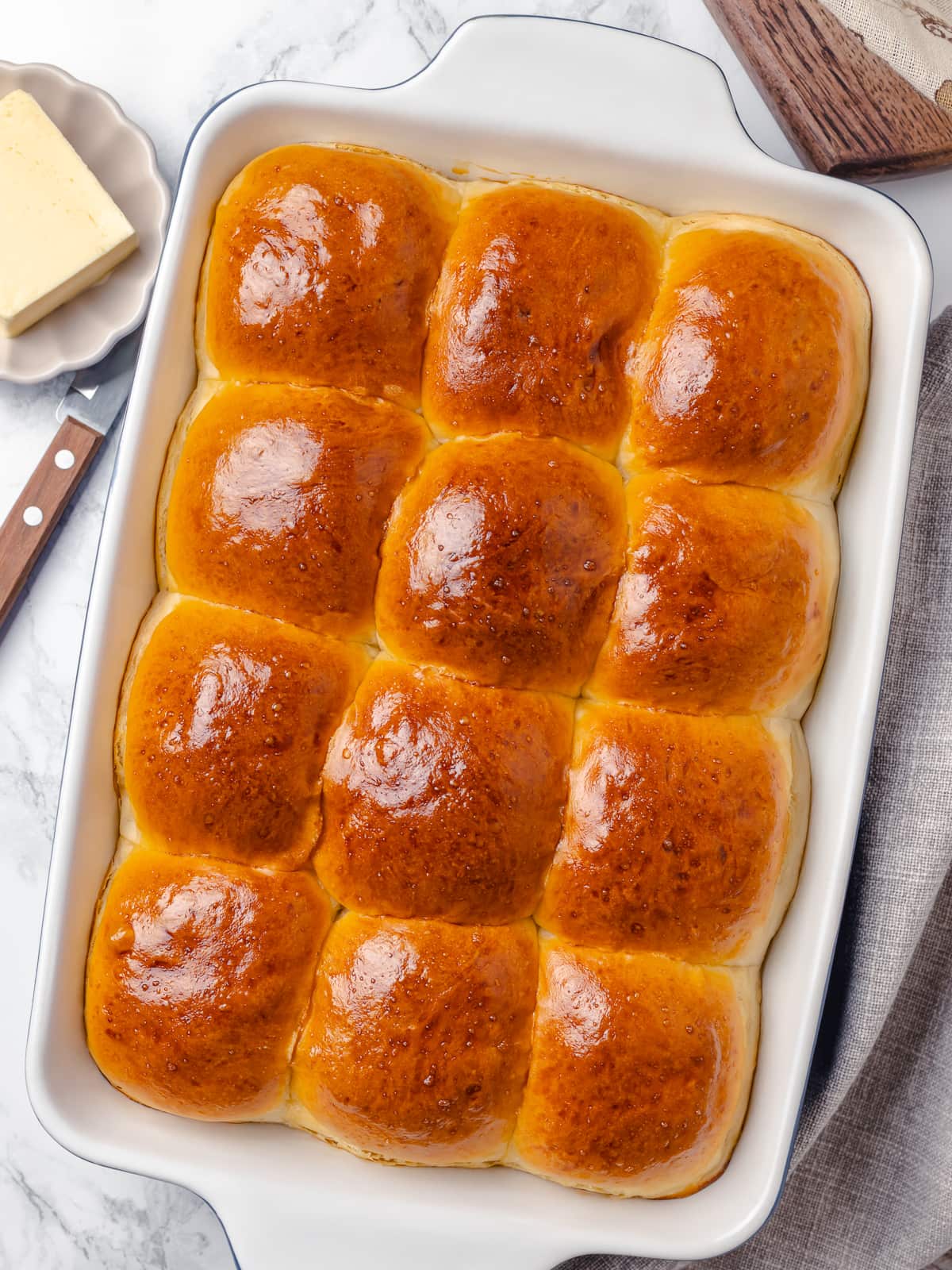 Fully baked dinner rolls with pillowy texture and evenly browned tops.