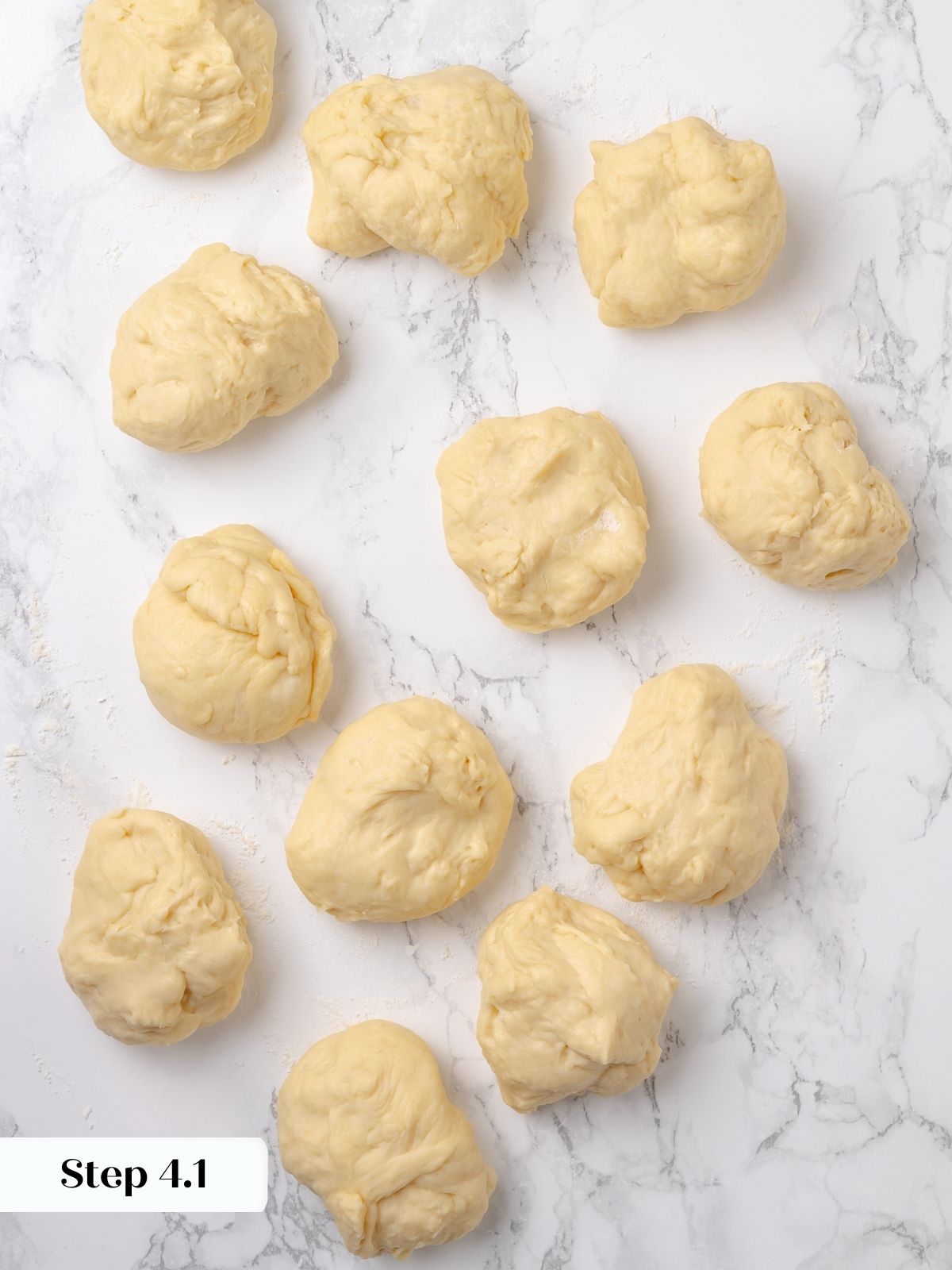 Dinner roll dough divided into equal portions before shaping.