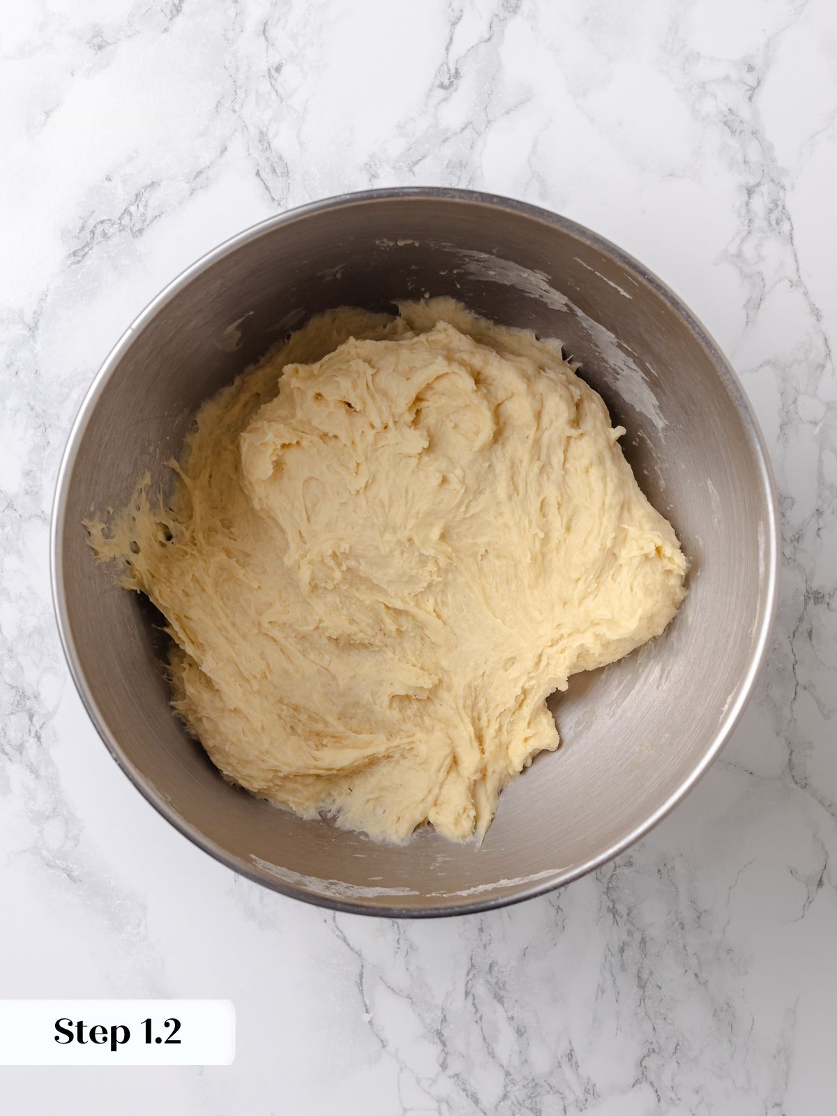 Mixed dough beginning to come together, slightly shaggy but cohesive.