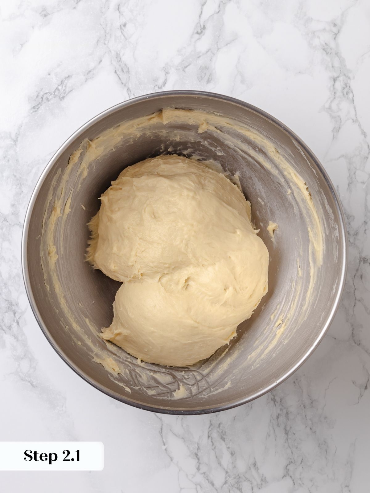 Soft dough being kneaded until smooth and elastic.