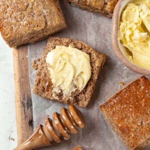 Warm whole wheat biscuit split open and spread with softened butter.