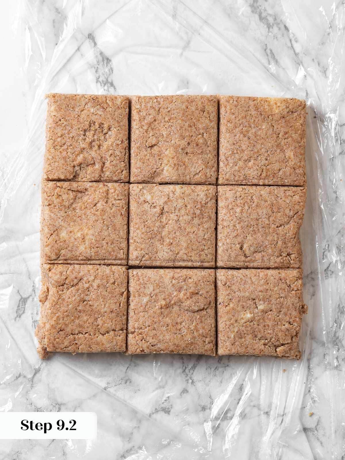 Dough cut into nine equal square biscuit portions.