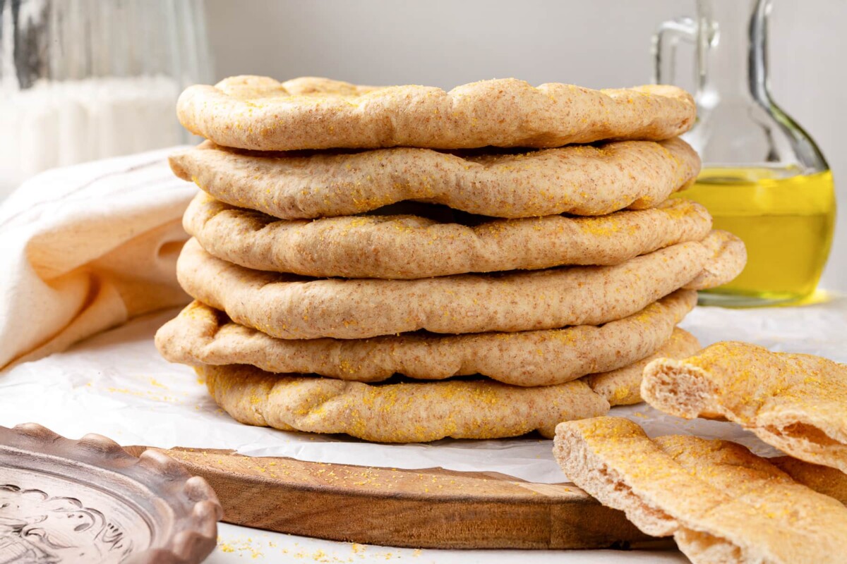 Whole wheat pita next to olive oil bottle before serving.