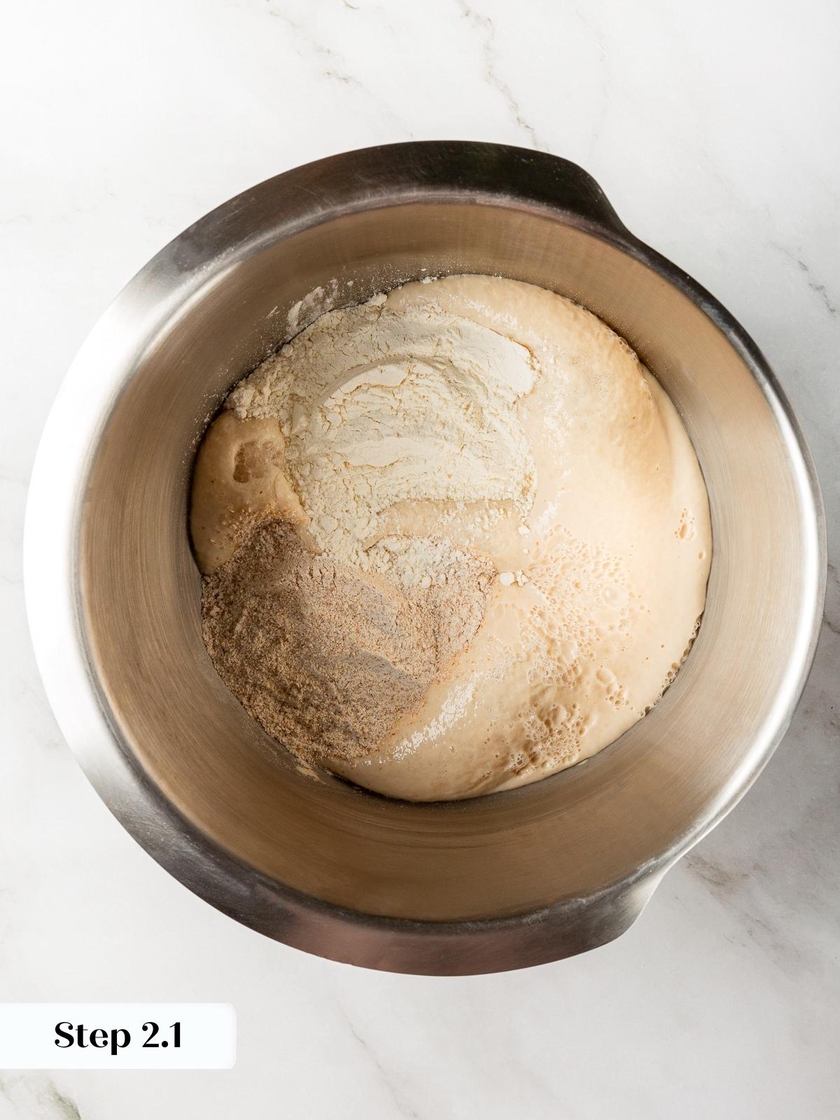 Bread flour and whole wheat flour added to bloomed yeast mixture.