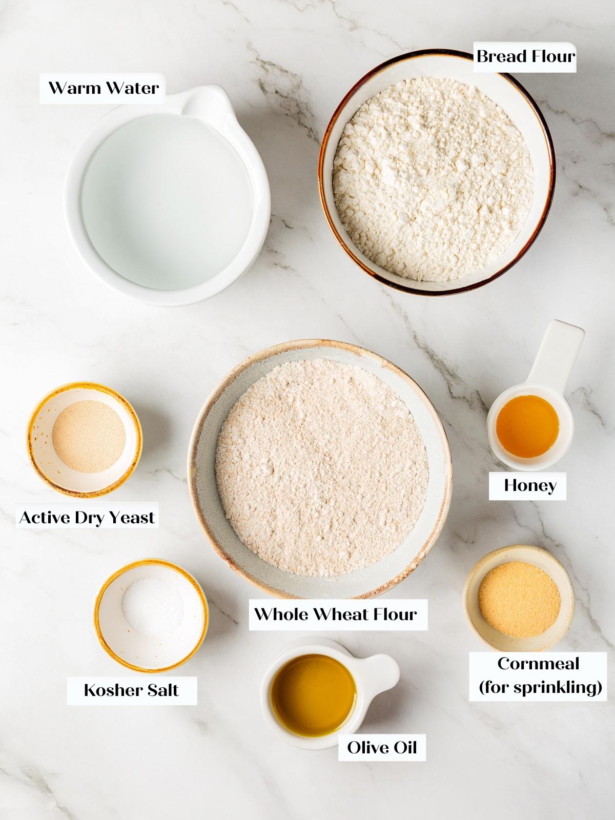 Yeast, flours, olive oil, and honey measured for pita bread.