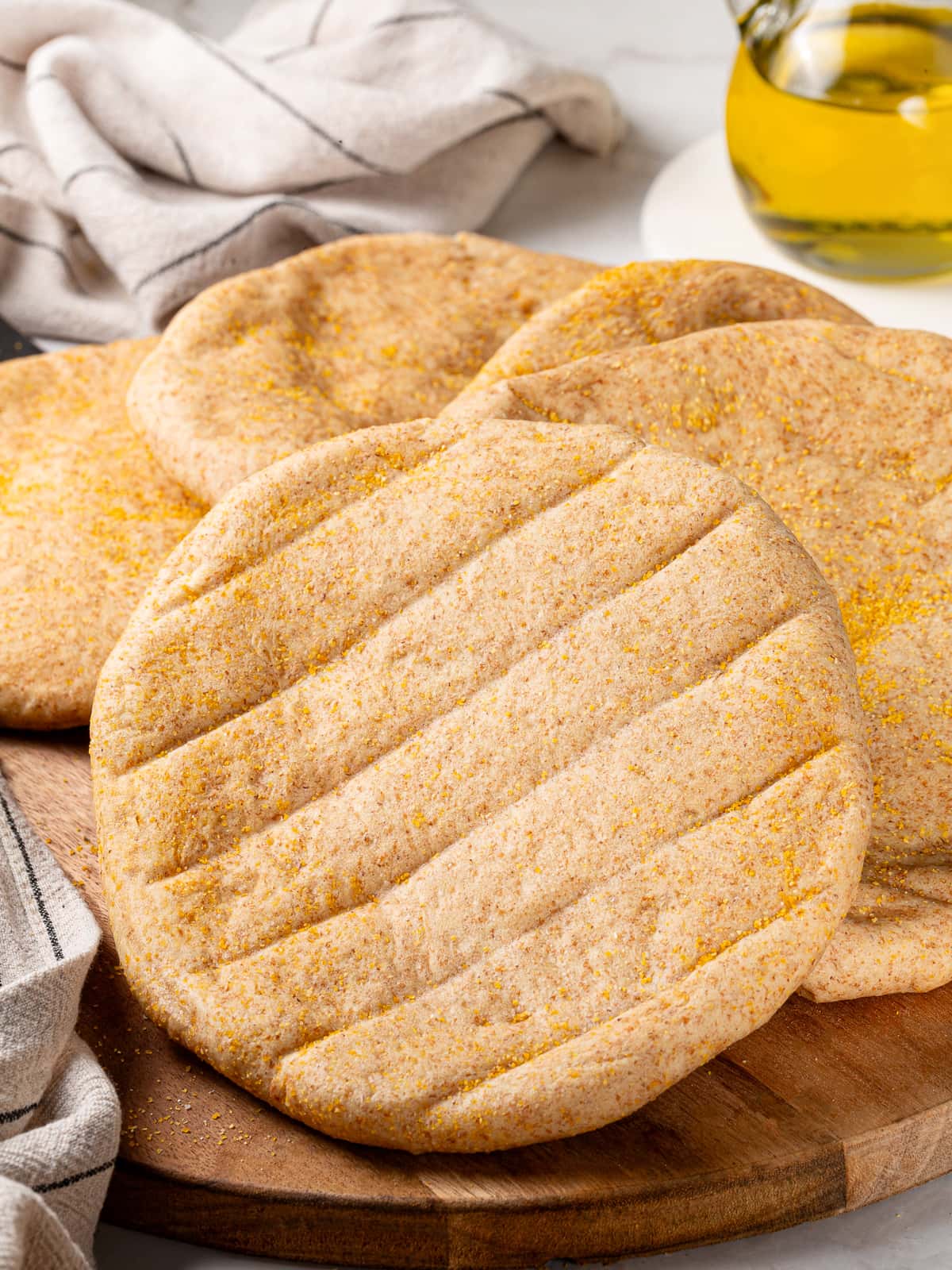 Pitas cooling briefly after baking to maintain softness.