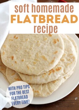 Stack of soft flatbread discs on a plate. Text overlay reads with pro tips for the best flatbread every time.