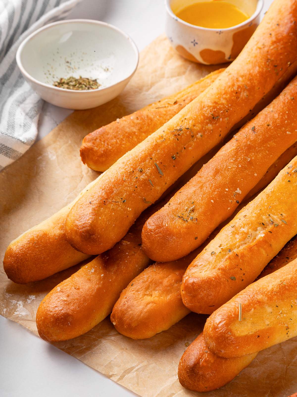 Soft breadsticks glistening with butter and garlic seasoning.