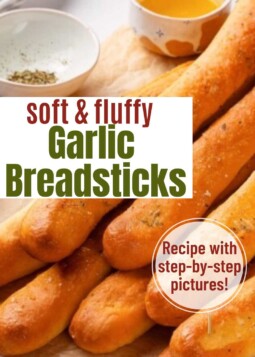 Homemade garlic breadsticks in a bread basket. Text overlay reads recipe with steb-by-step pictures.