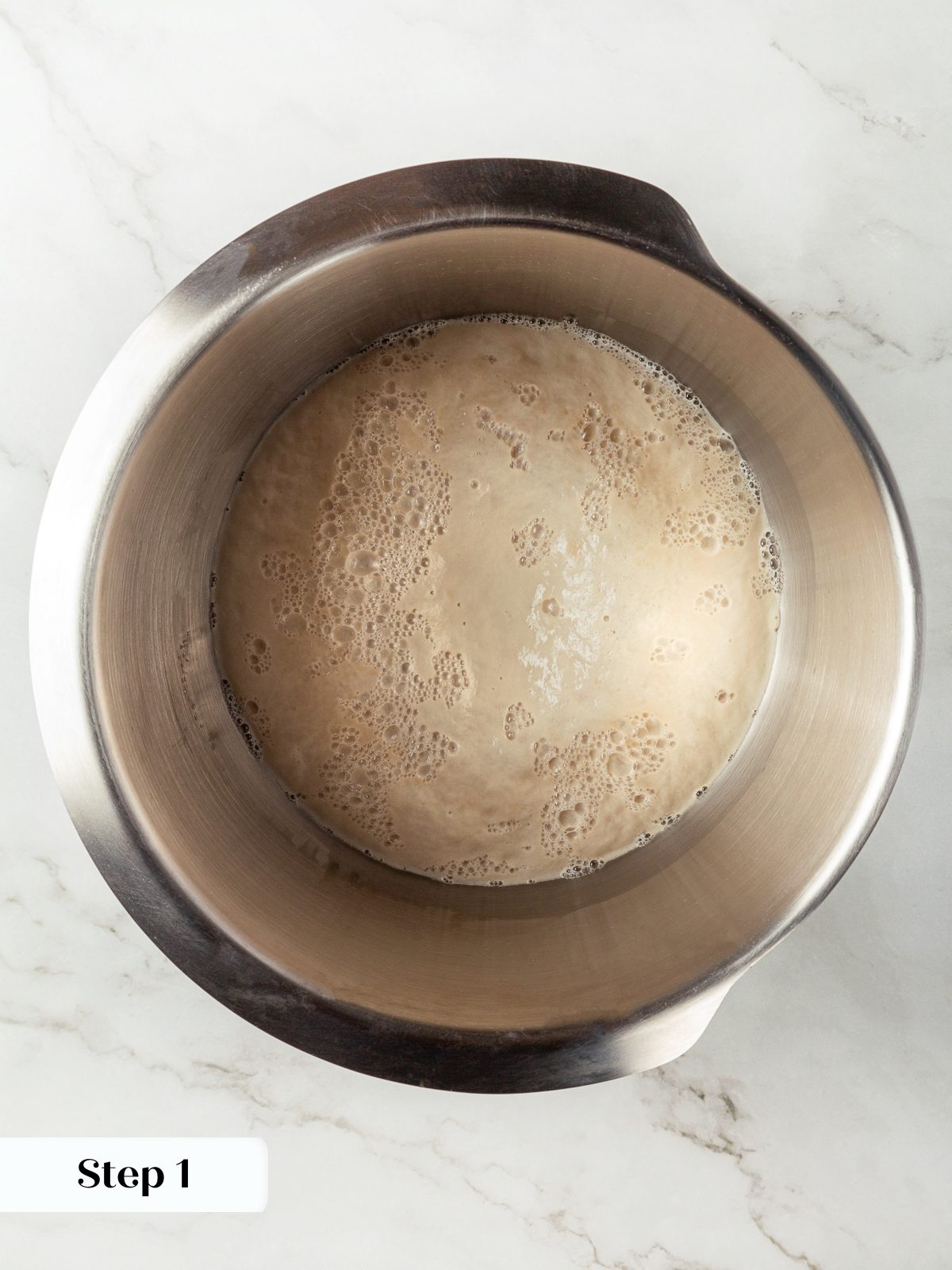 Yeast blooming in warm water creating foamy mixture for breadstick dough.