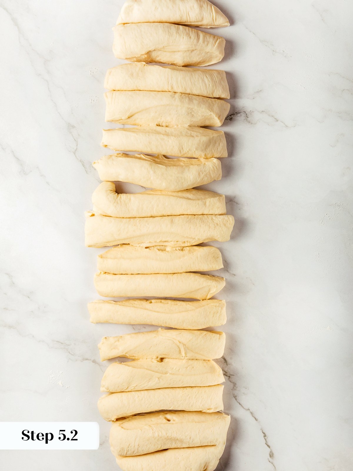 Dough log sliced into equal portions ready for shaping breadsticks.