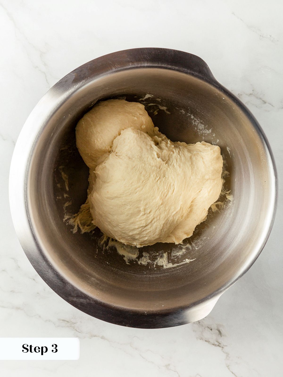 Soft slightly tacky dough prepared during garlic breadstick preparation.