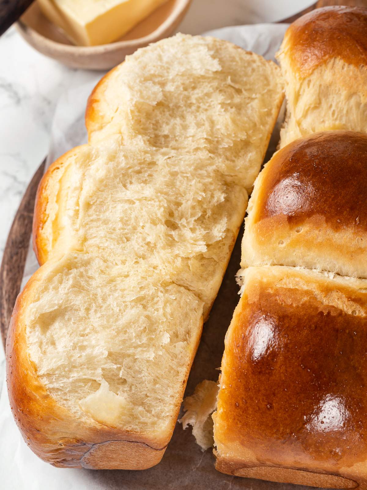 Milk bread rolls showing fluffy airy crumb from tangzhong technique.