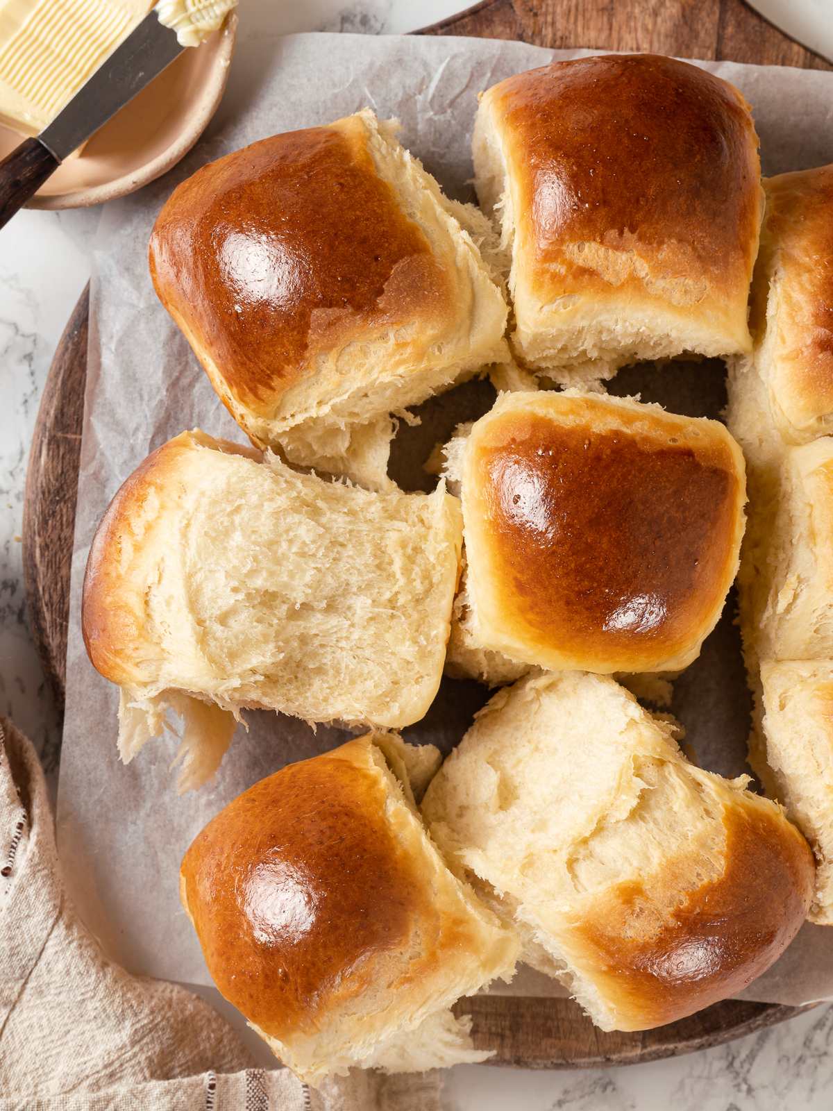 Group of milk bread rolls with soft texture and golden tops.