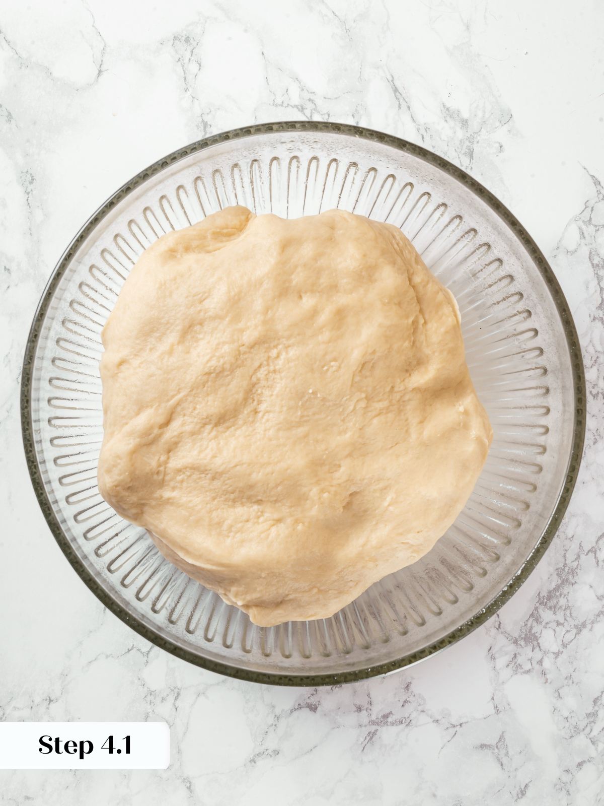 Milk bread dough resting in bowl before first proofing stage.