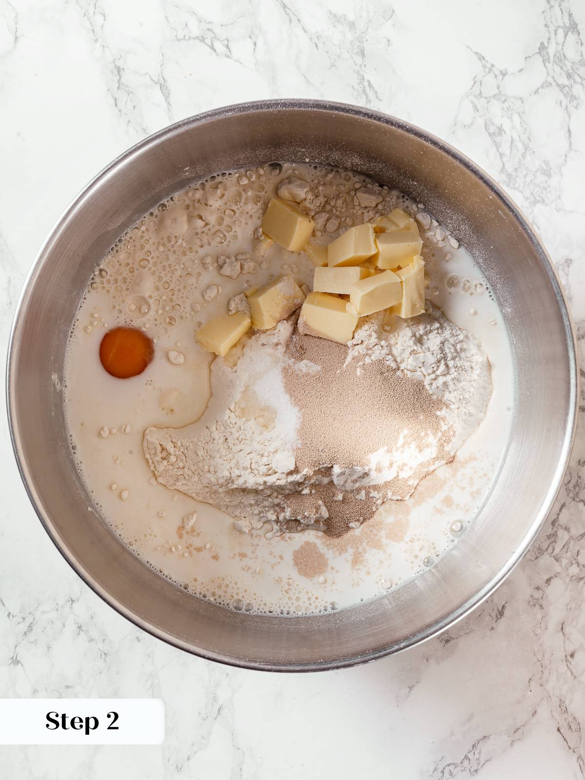 Ingredients combined in mixer bowl to form milk bread dough.